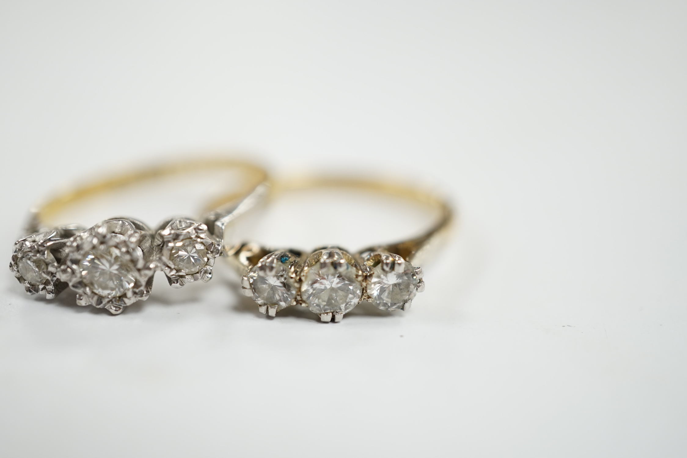 Two 18ct, plate and illusion set three stone diamond rings, sizes O & P, gross weight 6.3 grams. Condition - fair to good